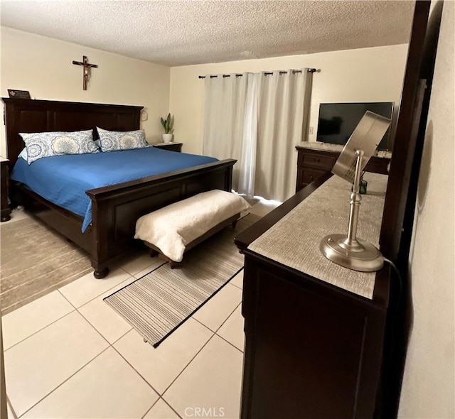 9620 San Vincente Ave, South Gate, CA 90280 - bedroom with a textured ceiling and light tile patterned floors
