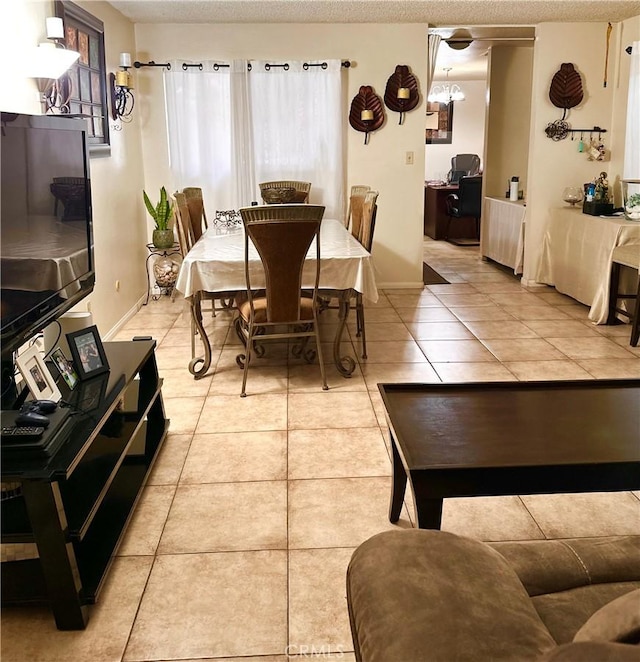 9620 San Vincente Ave, South Gate, CA 90280 - dining area with light tile patterned floors, a textured ceiling, and healthy amount of natural light