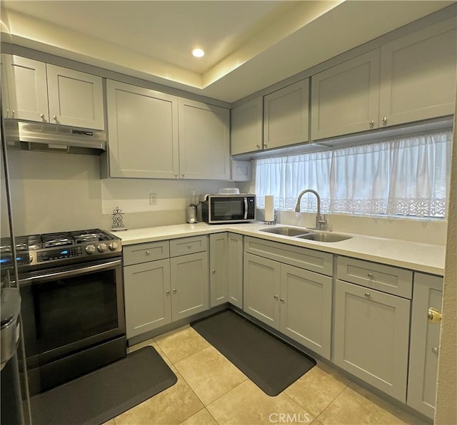 9620 San Vincente Ave, South Gate, CA 90280 - kitchen featuring under cabinet range hood, gas stove, light tile patterned floors, light countertops, and recessed lighting