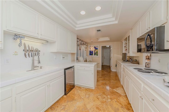 662 Via Zapata, Riverside, CA 92507 - kitchen with black microwave, a peninsula, white cabinetry, tasteful backsplash, and recessed lighting