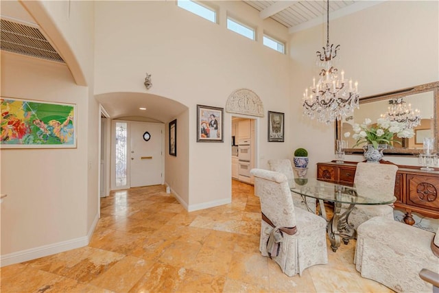 662 Via Zapata, Riverside, CA 92507 - dining area with arched walkways, a towering ceiling, a chandelier, and a wood ceiling with exposed beams