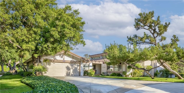 662 Via Zapata, Riverside, CA 92507 - obstructed view of property featuring concrete driveway, stucco siding, an attached garage, and a front lawn