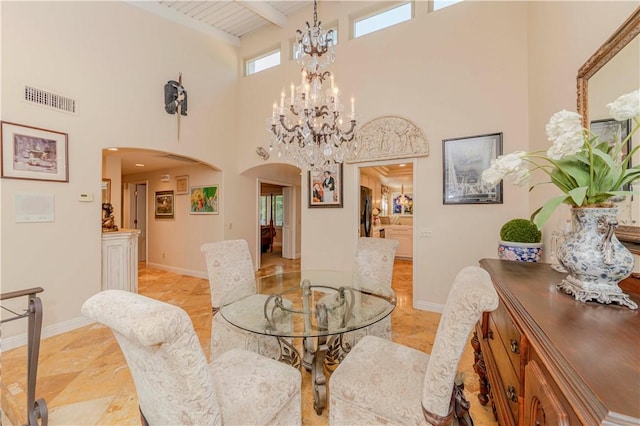 662 Via Zapata, Riverside, CA 92507 - dining area with arched walkways, a high ceiling, a chandelier, and beam ceiling