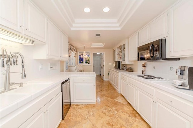 662 Via Zapata, Riverside, CA 92507 - kitchen with a raised ceiling, dishwasher, tile counters, a peninsula, and white cabinetry