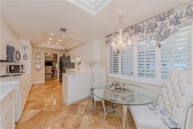 662 Via Zapata, Riverside, CA 92507 - kitchen featuring a chandelier, white cabinets, freestanding refrigerator, light countertops, and crown molding