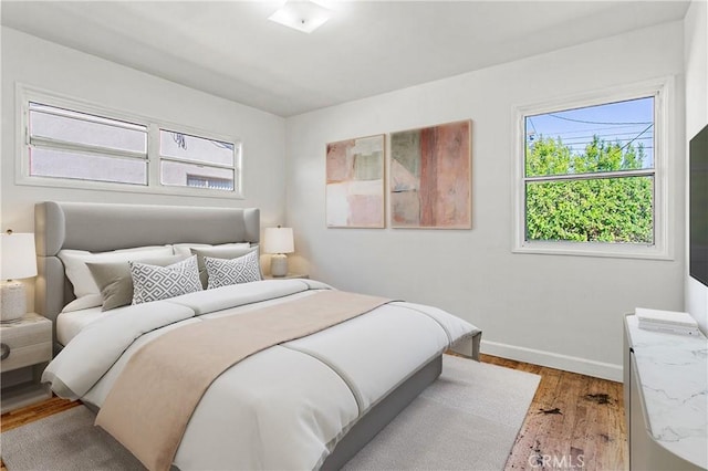 14202 Del Amo Ave, Tustin, CA 92780 - bedroom featuring multiple windows and wood finished floors