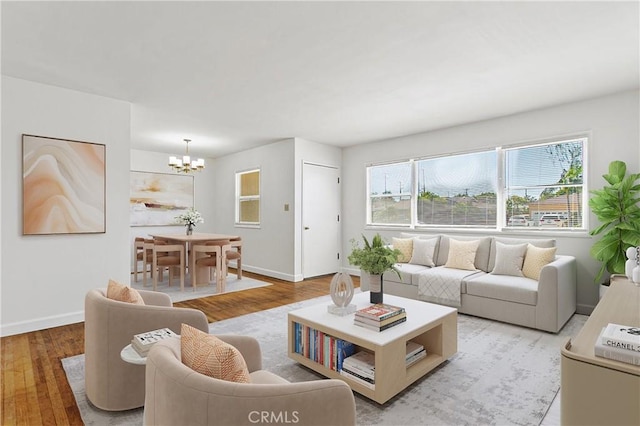14202 Del Amo Ave, Tustin, CA 92780 - living area featuring a chandelier, healthy amount of natural light, and light wood-style floors