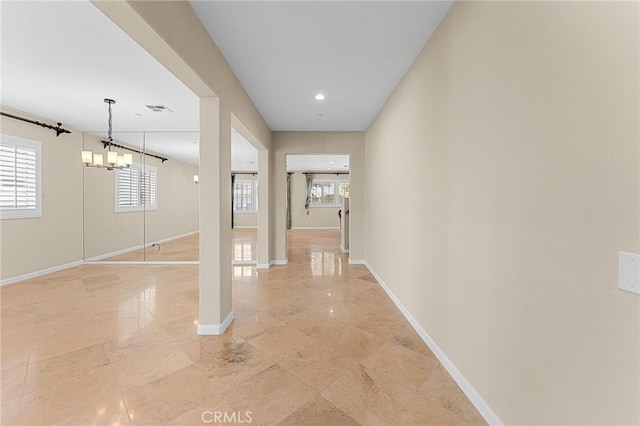 1581 Margit St, Redlands, CA 92374 - corridor featuring plenty of natural light and a chandelier
