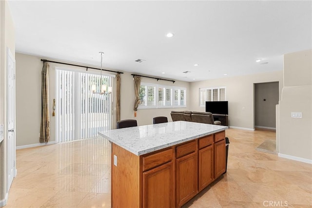 1581 Margit St, Redlands, CA 92374 - kitchen featuring a center island, brown cabinets, light stone counters, a chandelier, and recessed lighting