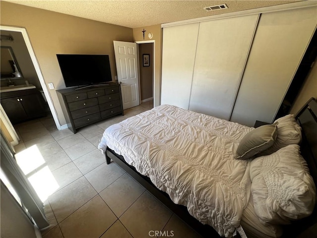 4214 Harrison St, Riverside, CA 92503 - bedroom with a closet, light tile patterned floors, and a textured ceiling