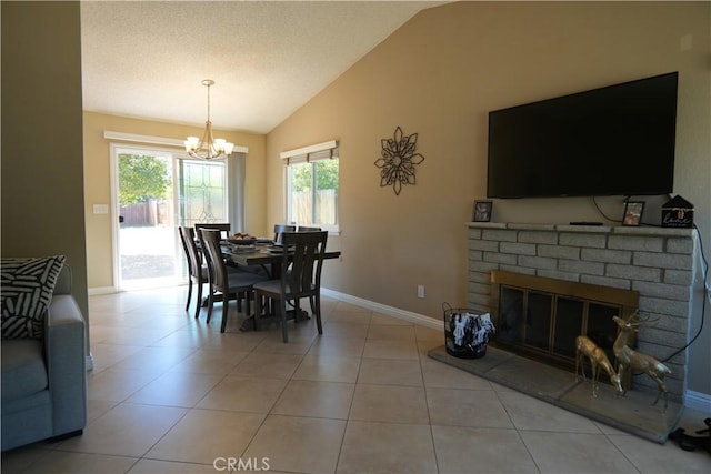 4214 Harrison St, Riverside, CA 92503 - dining room with a chandelier, lofted ceiling, healthy amount of natural light, a brick fireplace, and light tile patterned floors