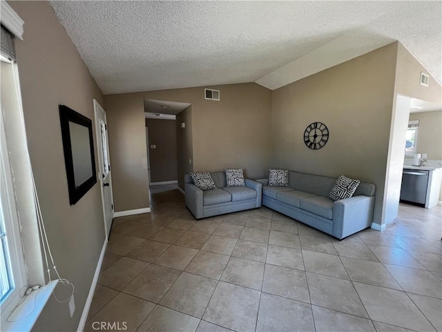 4214 Harrison St, Riverside, CA 92503 - living room with vaulted ceiling, light tile patterned floors, and a textured ceiling