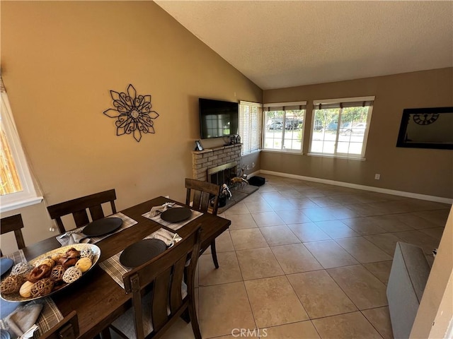 4214 Harrison St, Riverside, CA 92503 - dining area with lofted ceiling, a brick fireplace, light tile patterned flooring, and a textured ceiling