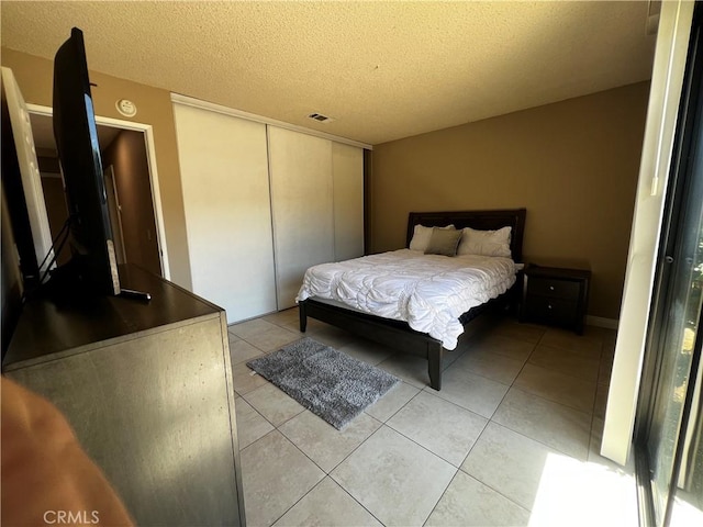 4214 Harrison St, Riverside, CA 92503 - bedroom with a textured ceiling, light tile patterned floors, and a closet