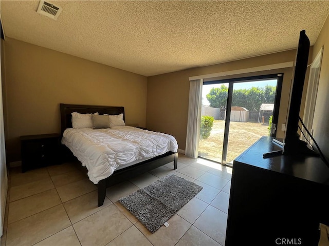 4214 Harrison St, Riverside, CA 92503 - bedroom featuring access to exterior, a textured ceiling, and light tile patterned flooring