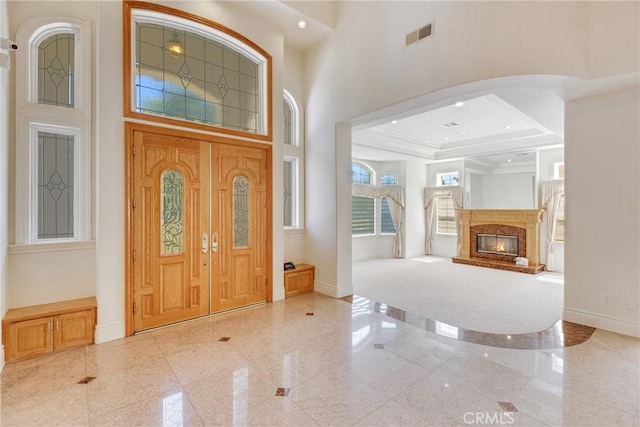 134 E Las Flores Ave, Arcadia, CA 91006 - foyer featuring granite tiled floors, a high ceiling, arched walkways, a high end fireplace, and recessed lighting