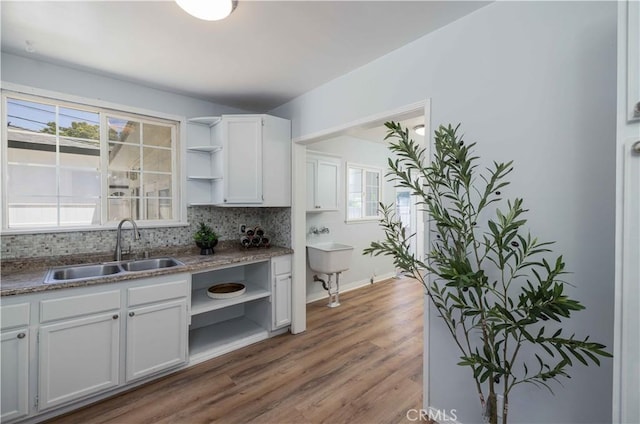 12108 Dunrobin Ave, Downey, CA 90242 - kitchen with open shelves, white cabinetry, tasteful backsplash, and wood finished floors