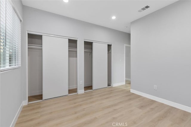 12108 Dunrobin Ave, Downey, CA 90242 - unfurnished bedroom with two closets, light wood-type flooring, and recessed lighting