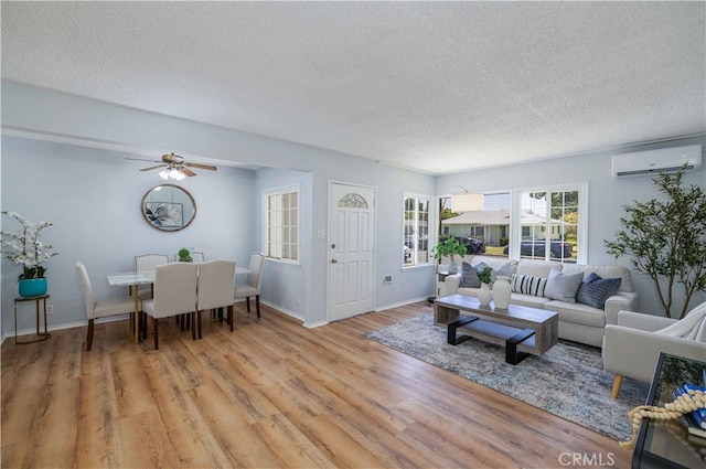 12108 Dunrobin Ave, Downey, CA 90242 - living room with a wall unit AC, a textured ceiling, light wood-type flooring, and ceiling fan
