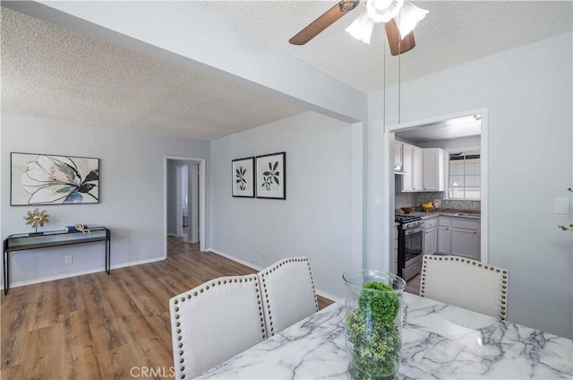 12108 Dunrobin Ave, Downey, CA 90242 - dining area featuring a textured ceiling, wood finished floors, and ceiling fan