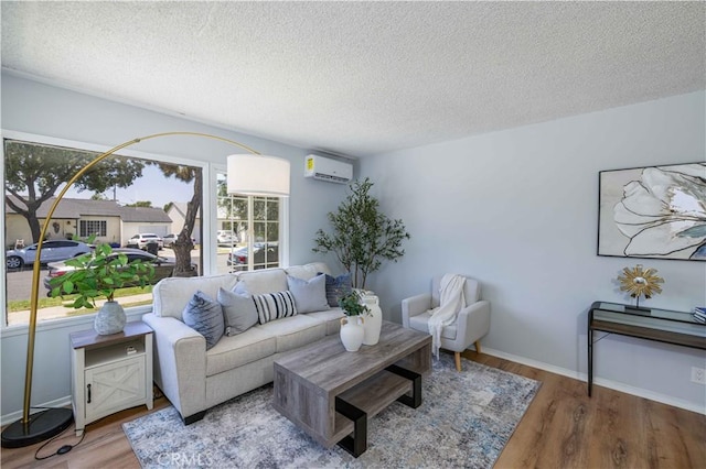 12108 Dunrobin Ave, Downey, CA 90242 - living area with a wall mounted air conditioner, a textured ceiling, and wood finished floors