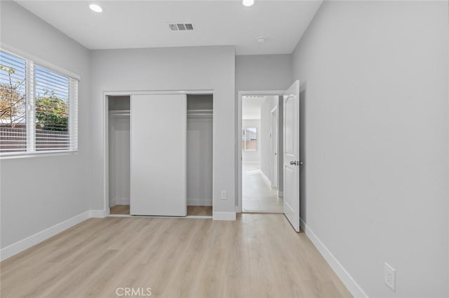 12108 Dunrobin Ave, Downey, CA 90242 - unfurnished bedroom featuring light wood-style floors, recessed lighting, and a closet