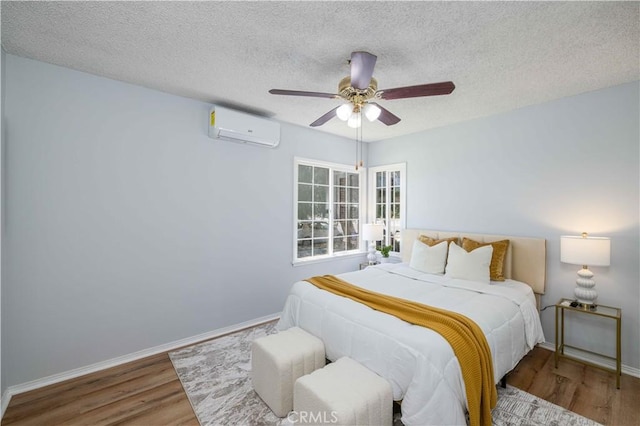 12108 Dunrobin Ave, Downey, CA 90242 - bedroom with a wall mounted air conditioner, wood finished floors, a textured ceiling, and a ceiling fan