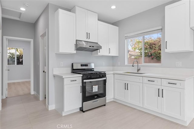 12108 Dunrobin Ave, Downey, CA 90242 - kitchen featuring gas stove, under cabinet range hood, light countertops, white cabinets, and recessed lighting