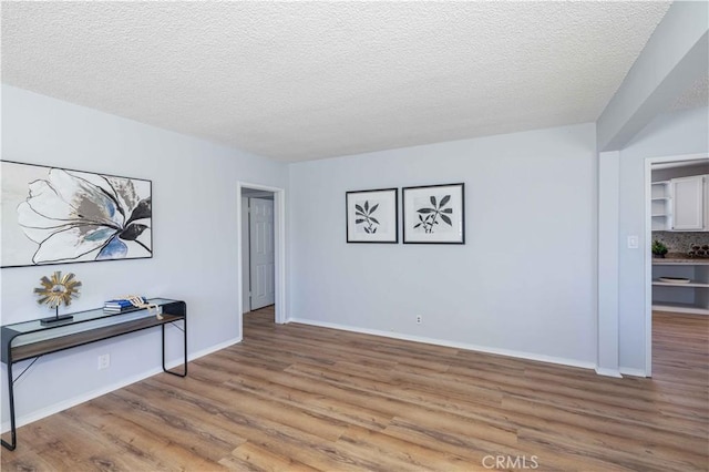 12108 Dunrobin Ave, Downey, CA 90242 - unfurnished room featuring wood finished floors and a textured ceiling