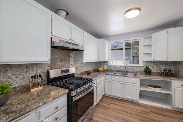 12108 Dunrobin Ave, Downey, CA 90242 - kitchen with gas stove, open shelves, under cabinet range hood, white cabinetry, and tasteful backsplash