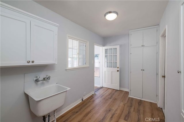 12108 Dunrobin Ave, Downey, CA 90242 - laundry area featuring wood finished floors and cabinet space