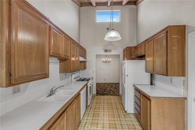 19950 Esquiline Ave, Walnut, CA 91789 - kitchen featuring white appliances, a chandelier, a towering ceiling, and backsplash