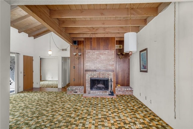 19950 Esquiline Ave, Walnut, CA 91789 - unfurnished living room featuring a wooden ceiling with exposed beams, a fireplace, wooden walls, and carpet flooring