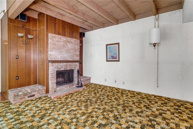 19950 Esquiline Ave, Walnut, CA 91789 - unfurnished living room featuring a wooden ceiling with exposed beams, a fireplace, wooden walls, and carpet