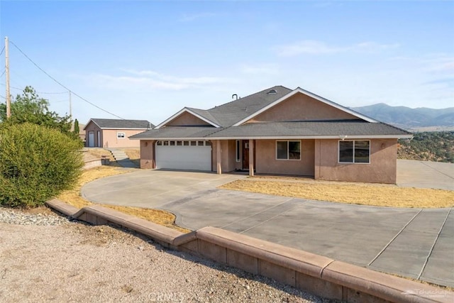 23309 Tak Ct, Tehachapi, CA 93561 - ranch-style home featuring a garage, stucco siding, driveway, and roof with shingles