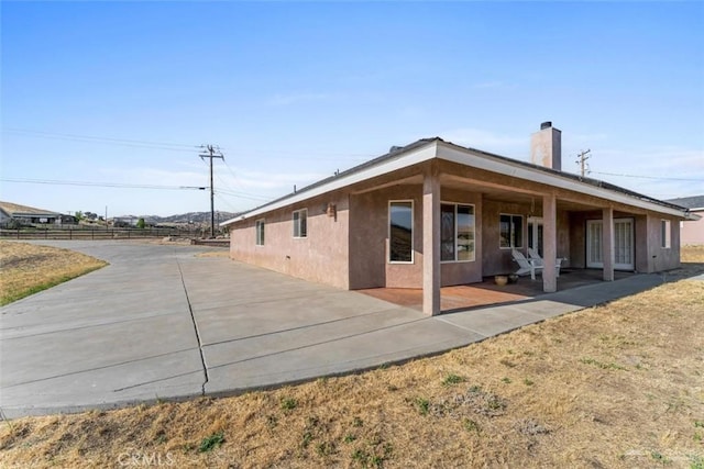23309 Tak Ct, Tehachapi, CA 93561 - rear view of property with a patio area, a chimney, and stucco siding