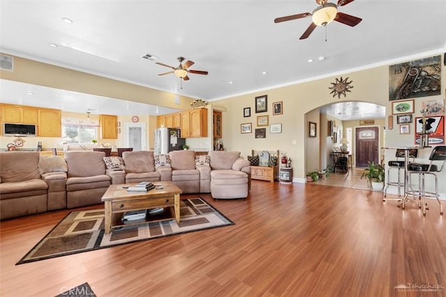 23309 Tak Ct, Tehachapi, CA 93561 - living area with ceiling fan, arched walkways, light wood-style flooring, crown molding, and recessed lighting