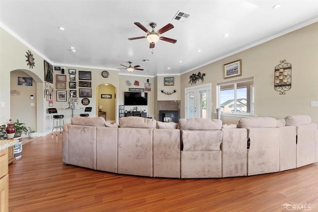 23309 Tak Ct, Tehachapi, CA 93561 - living room with arched walkways, ceiling fan, crown molding, light wood-style floors, and recessed lighting