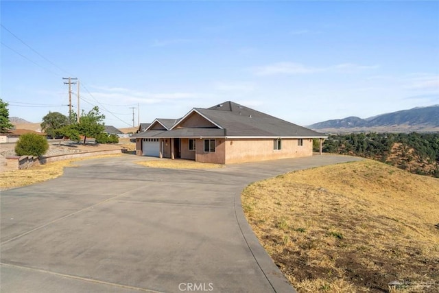 23309 Tak Ct, Tehachapi, CA 93561 - view of front facade with an attached garage, asphalt driveway, and a mountain view