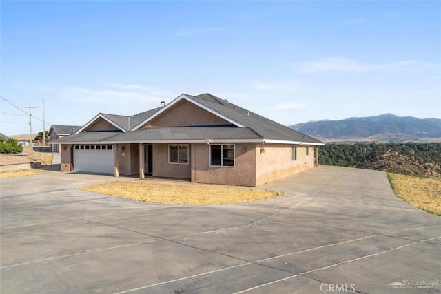 23309 Tak Ct, Tehachapi, CA 93561 - single story home with driveway, a mountain view, an attached garage, covered porch, and stucco siding