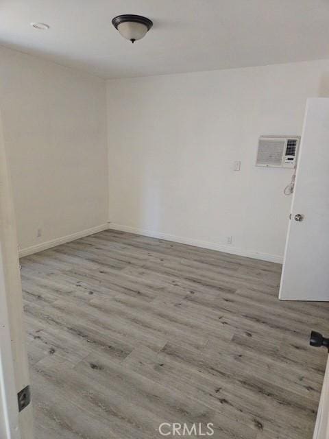 2467 California St, Huntington Park, CA 90255 - unfurnished room with wood finished floors and a wall unit AC
