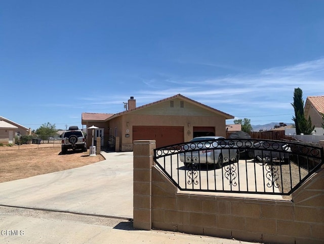 20151 Serrano Rd, Apple Valley, CA 92307 - view of front of home with a garage, a chimney, concrete driveway, and stucco siding