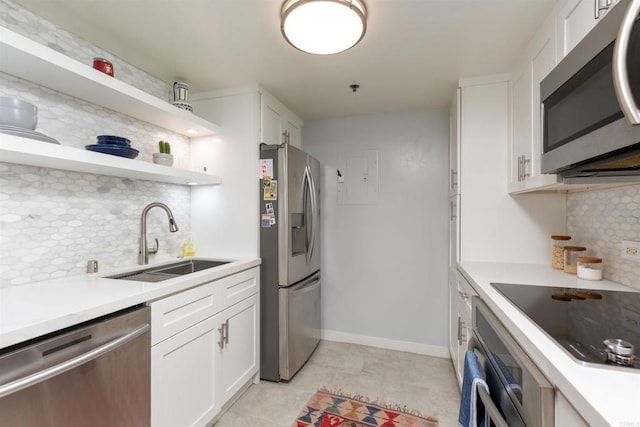 425 W Beech St Unit 613, San Diego, CA 92101 - kitchen with appliances with stainless steel finishes, backsplash, white cabinetry, and light countertops