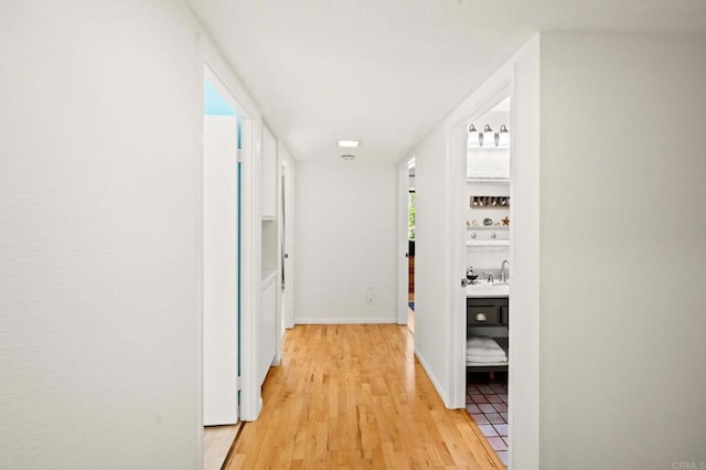 3432 Mount Ariane Dr, San Diego, CA 92111 - hallway featuring light wood finished floors and a sink