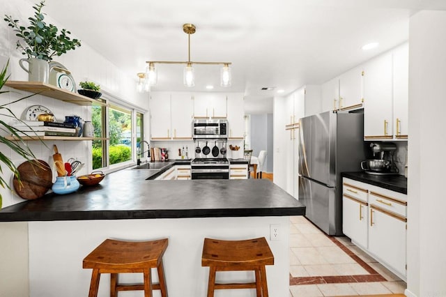 3432 Mount Ariane Dr, San Diego, CA 92111 - kitchen featuring stainless steel appliances, dark countertops, a peninsula, recessed lighting, and light tile patterned floors