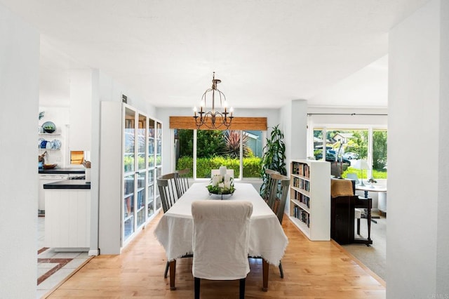 3432 Mount Ariane Dr, San Diego, CA 92111 - dining space with a chandelier and light wood-style flooring