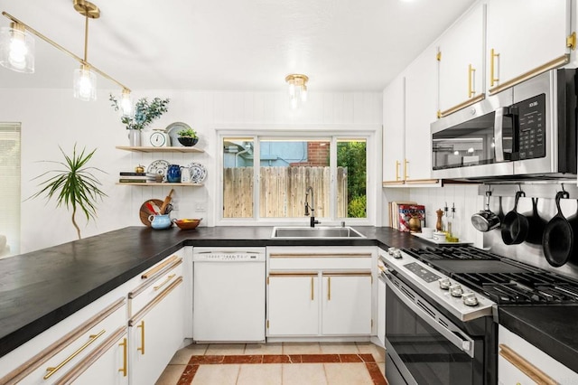 3432 Mount Ariane Dr, San Diego, CA 92111 - kitchen featuring appliances with stainless steel finishes, dark countertops, light tile patterned floors, inlaid floor details, and pendant lighting