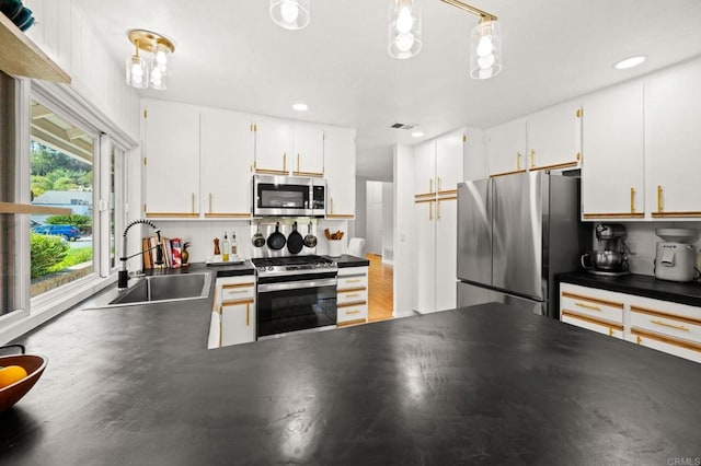 3432 Mount Ariane Dr, San Diego, CA 92111 - kitchen with stainless steel appliances, dark countertops, white cabinets, recessed lighting, and wood finished floors