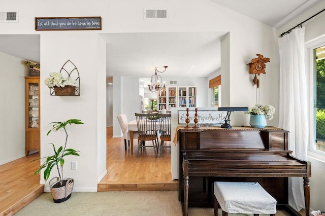 3432 Mount Ariane Dr, San Diego, CA 92111 - carpeted dining room featuring healthy amount of natural light, a chandelier, lofted ceiling, and wood finished floors