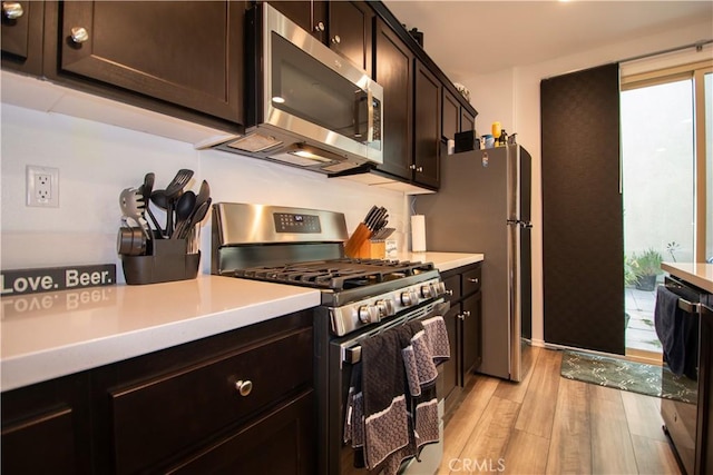 29392 Tourmaline Way, Winchester, CA 92596 - kitchen featuring stainless steel appliances, light wood finished floors, light countertops, and dark brown cabinetry